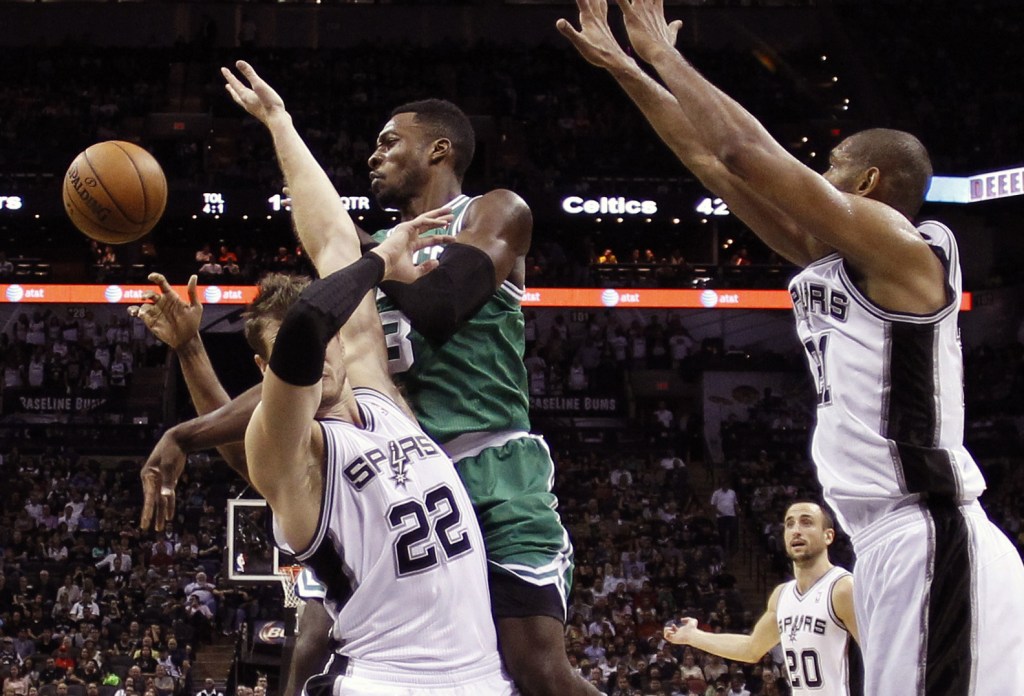 Boston’s Jeff Green is defended by San Antonio’s Tiago Splitter, 22, as he tries to score during Wednesday night’s game in Texas, won by the Spurs.