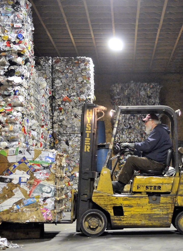 Ron Slater, manager of the Sandy River Recycling Association, loads a pallet of cardboard onto a scale in Farmington last March.