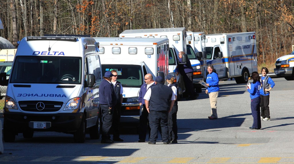 Photo by Jeff Pouland Ambulance crews wait to receive patients outside the Thayer Center for Health in Waterville on Saturday before transporting them to the new Alfond Center for Health in Augusta. The Thayer Center for Health will remain open as an outpatient facility with a 24-hour emergency department.