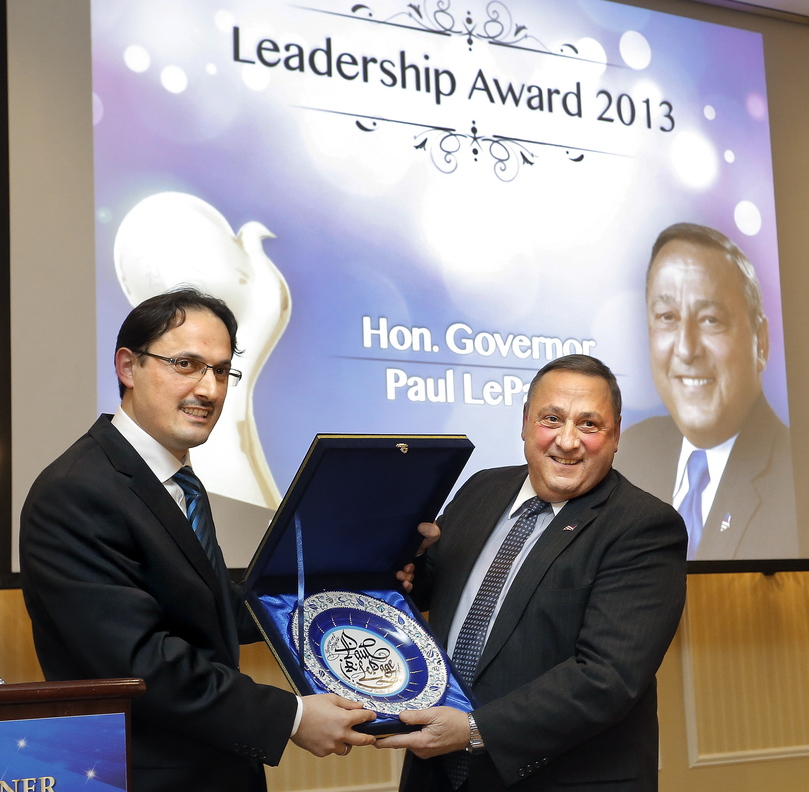 Eyup Sener, left, president of the Turkish Cultural Center Maine, presents Gov. Paul LePage with a traditional Turkish plate after LePage was honored with a leadership award at an annual Friendship Dinner held by the Turkish Cultural Center at the Sable Oaks Marriott in South Portland Tuesday.