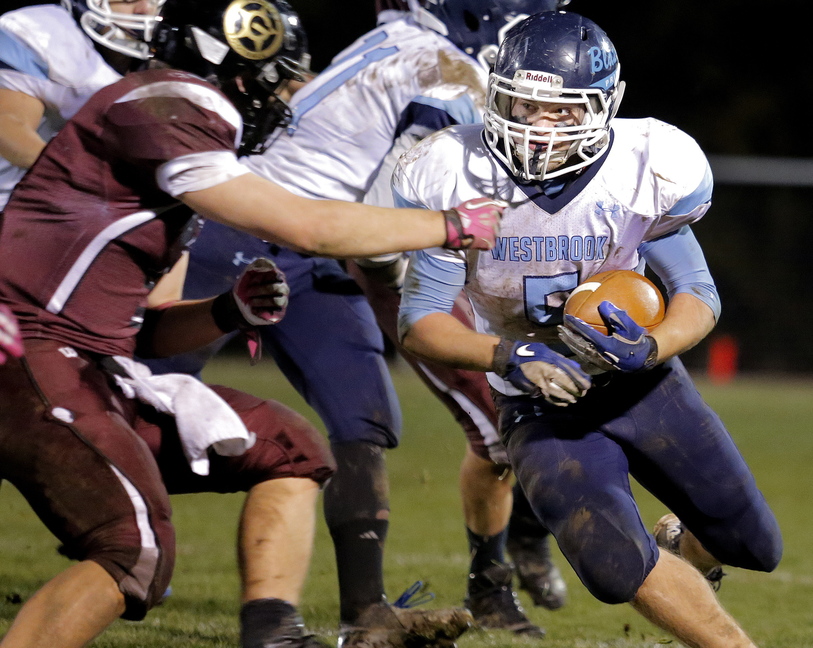 Kyle Heath looks for a way past Sam Peck of Greely in the first half of their Western Class B quarterfinal Friday night. Westbrook atoned for an earlier loss to the Rangers, scoring a 26-19 victory.