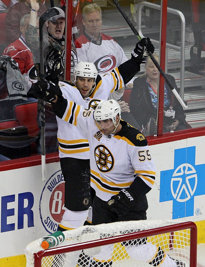 Milan Lucic and Johnny Boychuk celebrate Boychuk’s third-period goal Monday night at Raleigh, N.C. The Bruins beat the Carolina Hurricanes, 4-1.