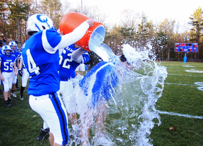 Kennebunk #34, Connor Donaher, and #62, Chad Cluff, douse coach Joe Rafferty in celebration of their win vs. Marshwood in the Western Class B regional final at Kennebunk High School Saturday, Nov. 16, 2013. Jill Brady/Staff Photographer.