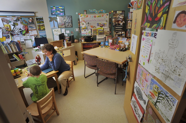 John Ewing/staff photographer... November 22, 2013…Abby Snyder is the only hospital based teacher in the state, working out of the pediatric ward at Maine Medical Center in Portland. Snyder works with one of her patients, Carter Blanche, 6, of Augusta, in her office at MMC.