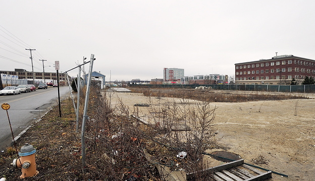 The proposed site of the first phase of the midtown development, viewed down Somerset Street toward Chestnut Street. The Maine Department of Health and Human Services building on Marginal Way is at right.