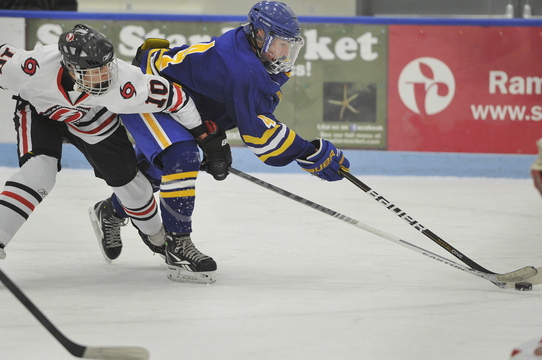 Falmouth’s Tyler Jordan tries to control the puck while being tightly defended by Scarborough’s Cam Nigro at the Alfond Forum in Biddeford on Monday night. Goals by Cam Loiselle and Cam Brochu paced Scarborough to a 2-0 win. Both teams are 1-1.