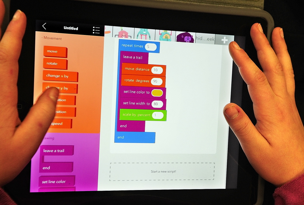 Jacek Twarog, a sixth-grader from Fayette, writes a program in the Hopscotch app on an iPad on Friday at Maranacook Middle School in Readfield.
