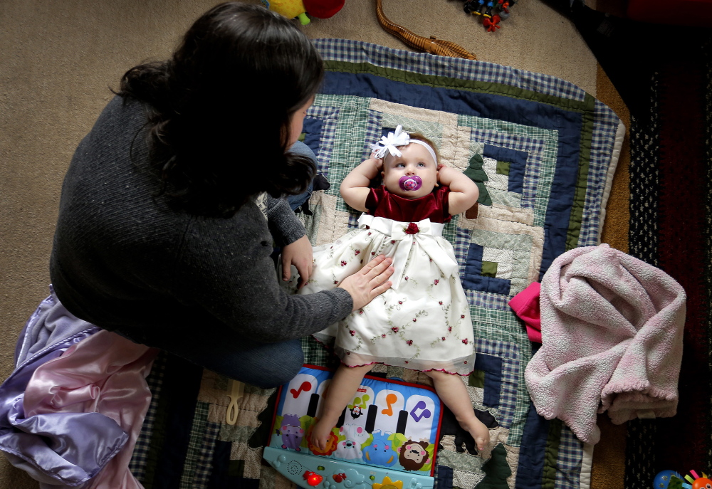 Meagan Patrick gives Addy a gentle caress at their Acton home earlier this month. The strain of medical marijuana that Patrick wants to treat Addy’s epilepsy with is called Charlotte’s Web and is grown in Colorado. One problem in obtaining it is that it’s a federally classified Schedule 1 drug that can’t legally be taken across state lines.