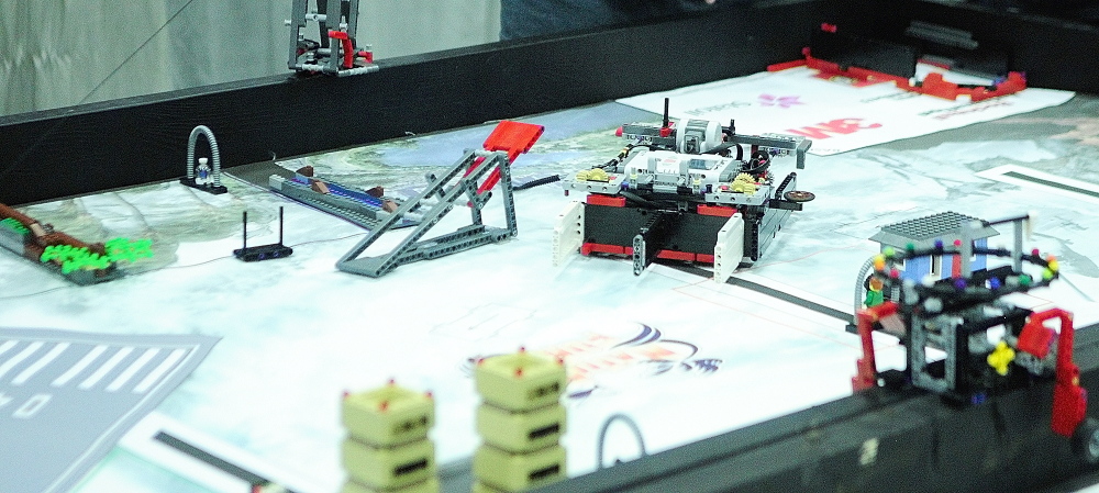 The Bridgineer team’s robot, center, moves across the table on its way to completing a task at the Maine FIRST Lego League Championship at the Augusta Civic Center on Saturday. The team is made up of Farmington middle school students.