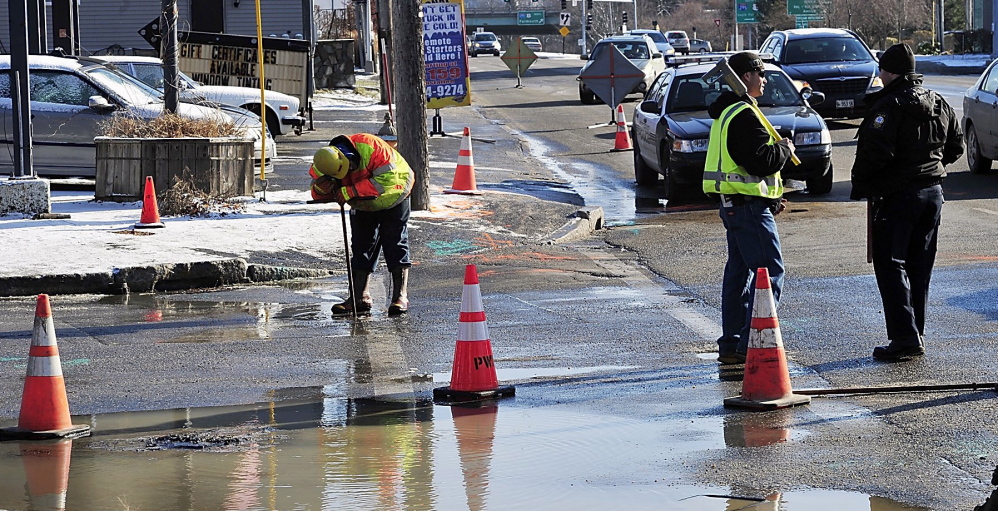 Central Maine Power and Portland Water District workers deal with a water main break in June. The district wants to raise rates to pay for replacement of aging pipes.