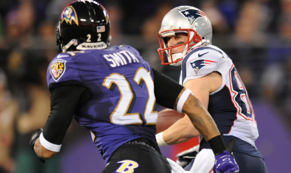 Receiver Danny Amendola rushes past Baltimore cornerback Jimmy Smith for good yardage during the first half of Sunday’s game.
