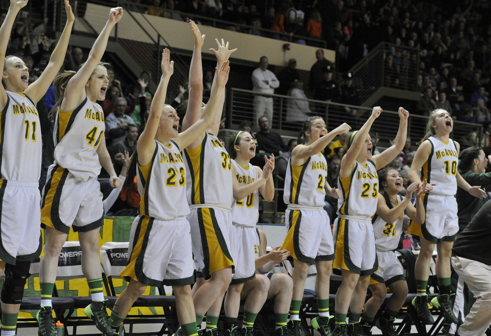 McAuley’s players celebrate as their team wraps up a 50-25 win over Windham in the Western Class A girls’ basketball championship game Saturday night at the Cumberland County Civic Center.