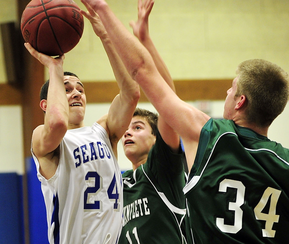 Waynflete’s unique zone defense does more than just stay back and wait for opponents to make the first move. On the contrary, the Flyers are aggressive, as Old Orchard Beach’s Joey Gildard discovered while being double-teamed by Milo Belleau, 11, and Pace Hutchinson.