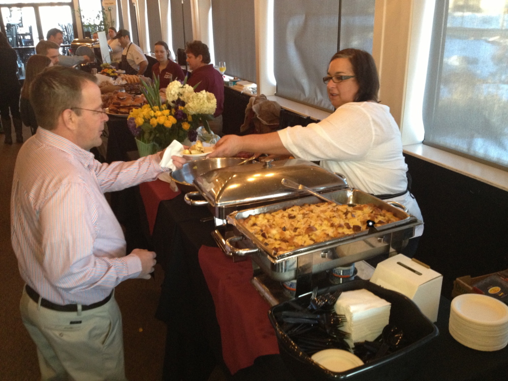 Lisa Kostopoulos serves Creme Brulée French Toast to first arrivals at the Incredible Breakfast Cookoff at Sea Dog Brewing in South Portland.