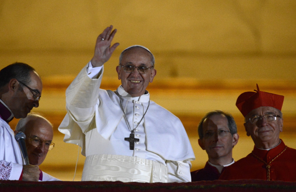 Pope Francis appears on the balcony of St. Peter’s Basilica after his election at the Vatican on March 13, 2013.