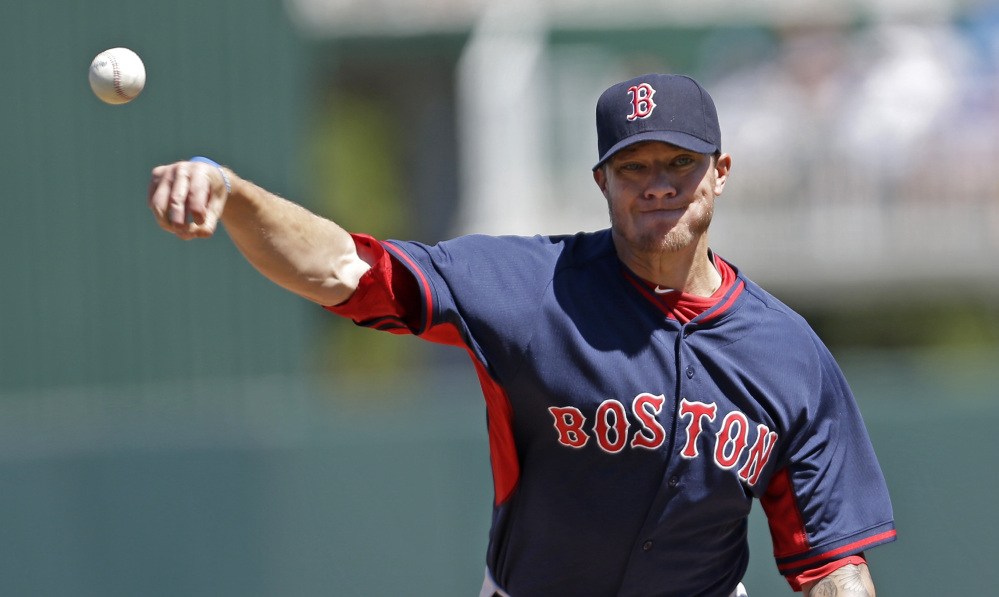 Boston’s Jake Peavy warms up prior to his first appearance of spring training. Peavy allowed two hits and a run in his three-plus innings.