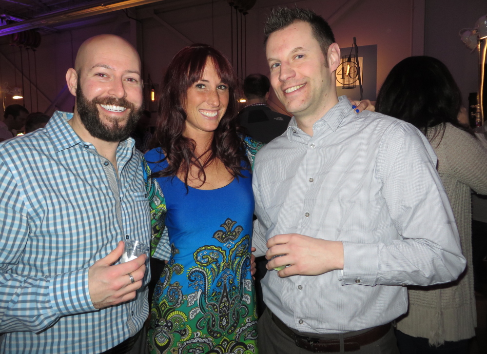 Jason Marineau and Colleen Young of Portland and Rick Farrar of Saco take a break from sampling cocktails and desserts.