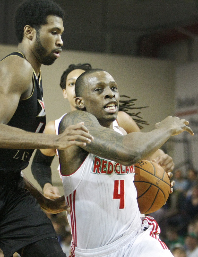 Guard Frank Gaines of the Maine Red Claws drives past the Erie BayHawks’ Scott Suggs during first-half action of Sunday afternoon’s game at The Expo.