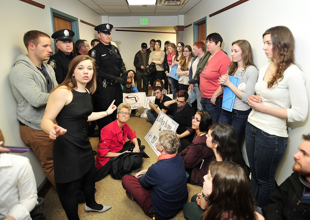 Brittany Hill, a fourth-year student at USM, speaks at a protest by about 100 students outside Provost Michael Stevenson’s office on the Portland campus Friday.