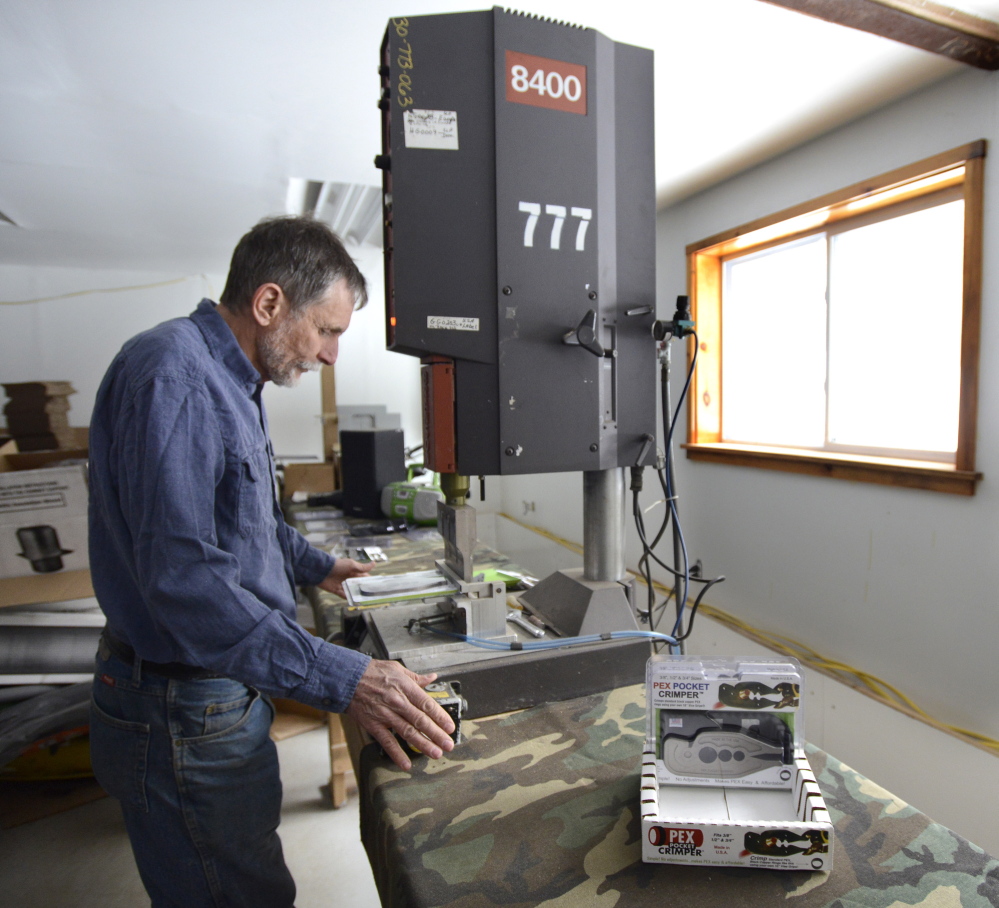 Dan Kidd, who now holds three patents, packages the patented PEX Pocket Crimper at his workshop in Limington. Ending the patent advice program is “counterproductive,” he says.