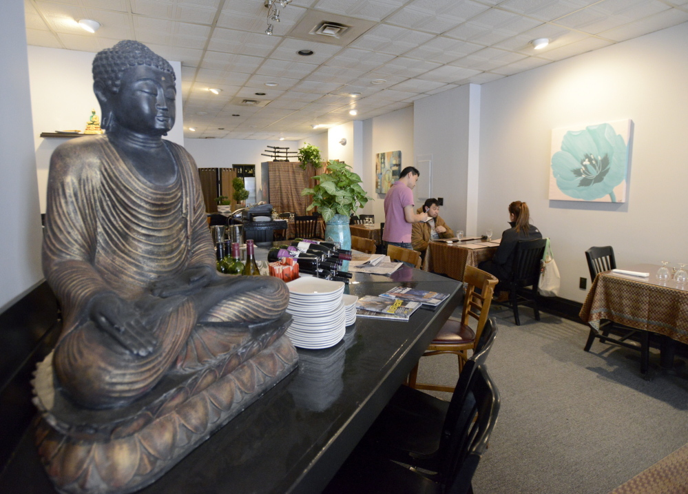 Sourasay Senesombath takes an order from customers at Thai 9’s new Old Port location.