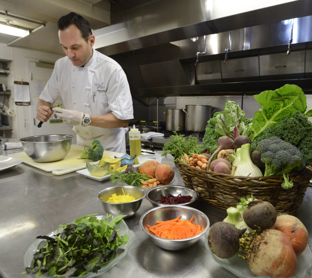 Kaldrovich trims broccoli for the salad, which also includes beet and carrot tops and fennel fronds.