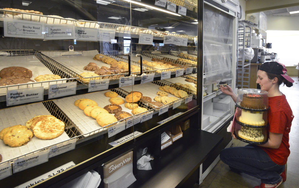 Pastry chef Brooke MacArthur stocks the cake display at Wild Oats Bakery and Cafe, where everything is homemade.