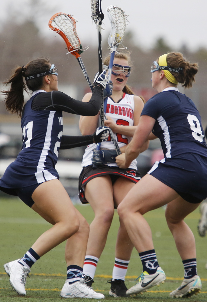 Abby Mills of Scarborough runs into trouble as Lane Simsarian, left, and Abby Belisle of Yarmouth converge. Scarborough, a perennial Class A contender, survived a second-half comeback bid by Yarmouth, the defending Eastern Class B champion.