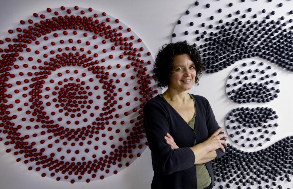 North Berwick artist Kim Bernard in her studio with her “Hydrogen Atomic Orbitals”