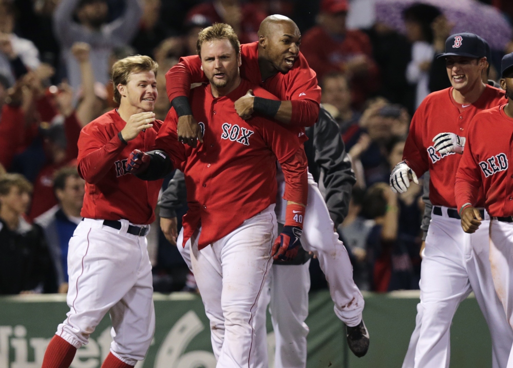 Red Sox teammates congratulate A.J. Pierzynski after his game-winning RBI triple in the bottom of the 10th inning off Tampa Bay Rays relief pitcher Juan Carlos Oviedo at Fenway Park on Friday. The Red Sox defeated the Rays 3-2.