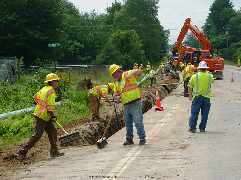 A construction crew lays pipe for Summit Natural Gas in Pittston.