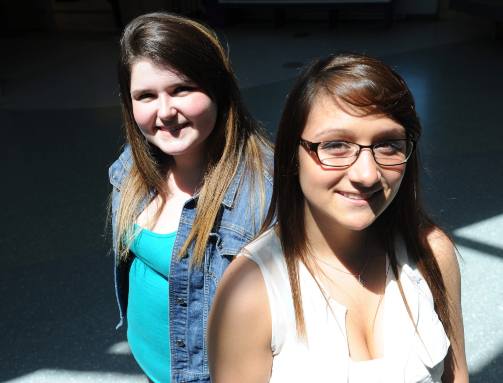 Michael G. Seamans/Morning Sentinel Iesha Blakeslee, 16, left, and Billie Stone, 18, helped an 86-year-old woman who fell and couldn’t get up on West River Road while trying to walk to her previous home early Tuesday morning.