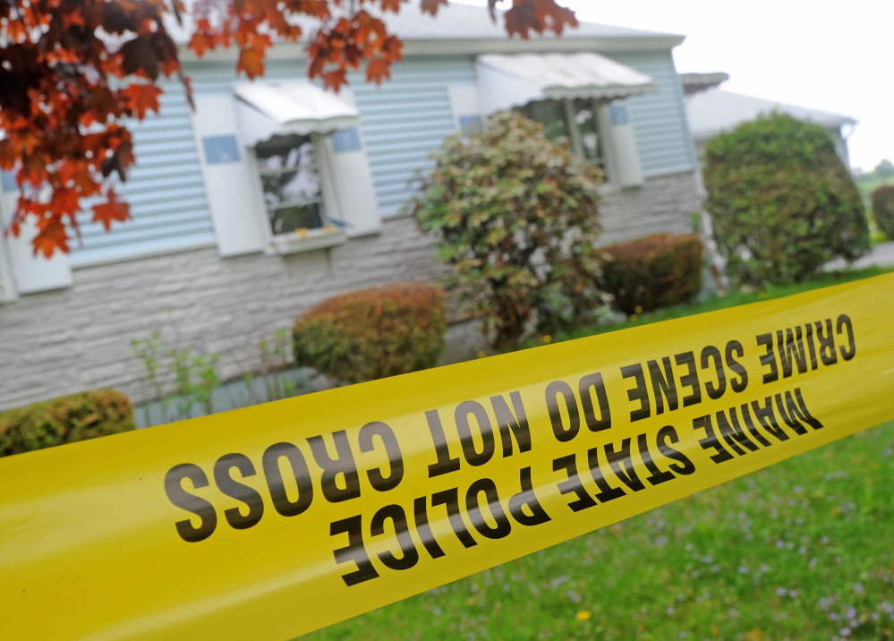 Morning Sentinel File Photo/Michael G. Seamans An investigator with the Maine State Police Major Crimes Unit dusts for fingerprints at the residence of Aurele Fecteau, 92, who was found dead in his home on Brooklyn Street in Waterville on May 23.