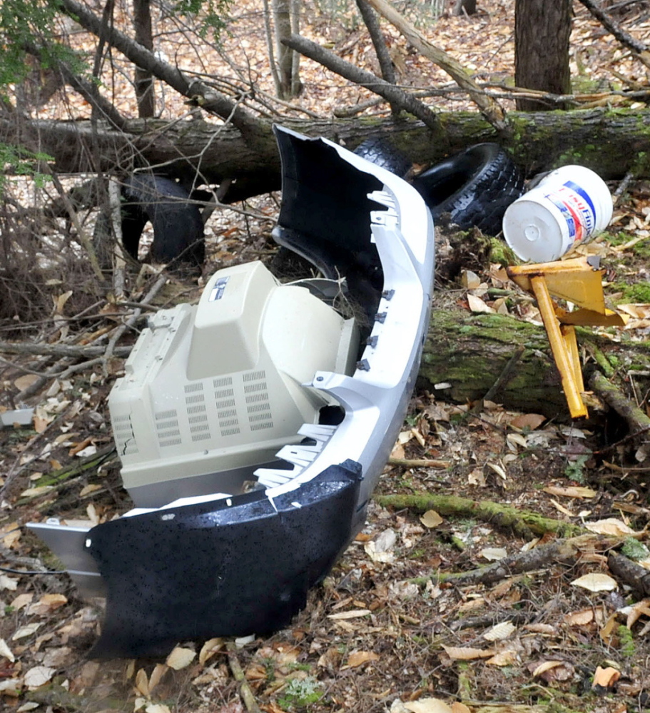 David Leaming/Morning Sentinel A television, a car bumper and tires lie discarded off Penney Road in Belgrade recently. Despite tough penalties, no one has been caught and fined for illegal dumping, officials say.