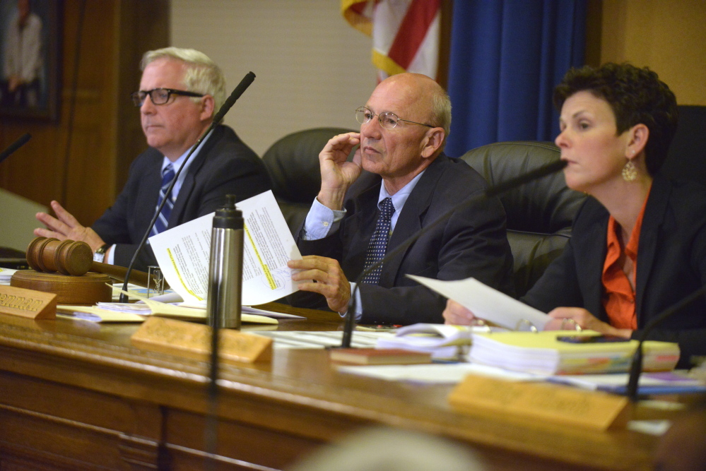 Portland Mayor Michael Brennan, flanked by City Manager Mark Rees (left) and Corporation Council Danielle West-Chuhta (right), listen to the public commentary on the issue of a five-cent fee on disposable bags.