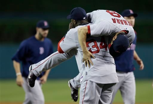 Boston Red Sox designated hitter David Ortiz lifts relief pitcher Koji Uehara after the ninth inning against the Detroit Tigers in Detroit on Sunday. The Associated Press