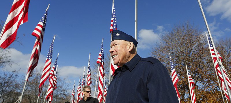 Korean War veteran Charles Tibbetts walks among flags honoring veterans after Yarmouthâs 2013 Veterans Day ceremony. Federal officials failed to heed years of warnings about the U.S. veterans health care system. 2013 File Photo/Derek Davis