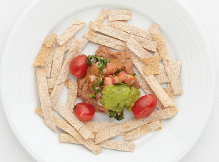 Sienna Mazone's Mexican Haystacks. The recipe features cherry tomatoes, refried beans and sweet potato.