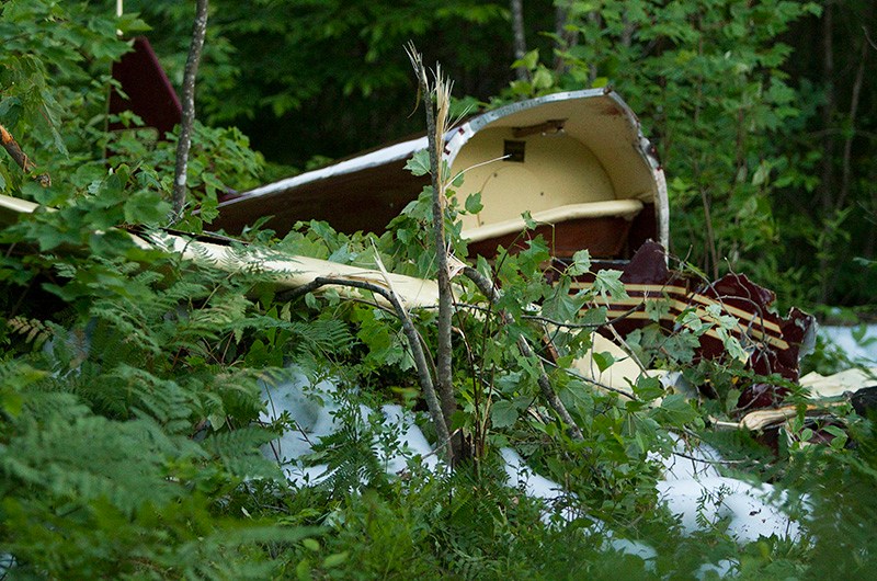 The wreckage of a 1942 Culver LFA single-engine plane sits in the woods where it crashed a few hundred yards from the Limington airport runway Saturday.  Clarke Tate, 52, of Gray was killed in the crash. Carl D. Walsh/Staff Photographer
