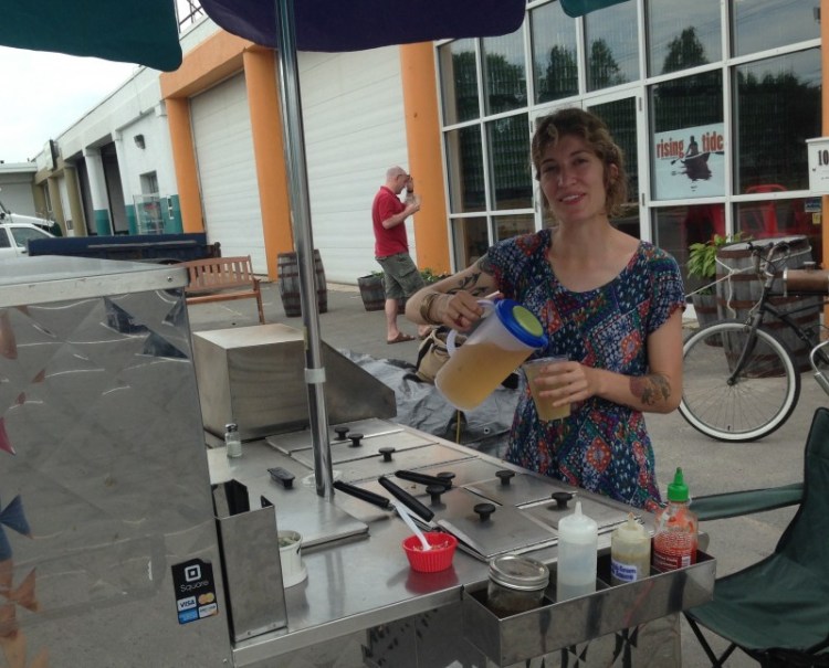 Gloria Pears pours an iced ginger tea at her Annapurna's Thali vegetarian food cart on Fox Street in Portland