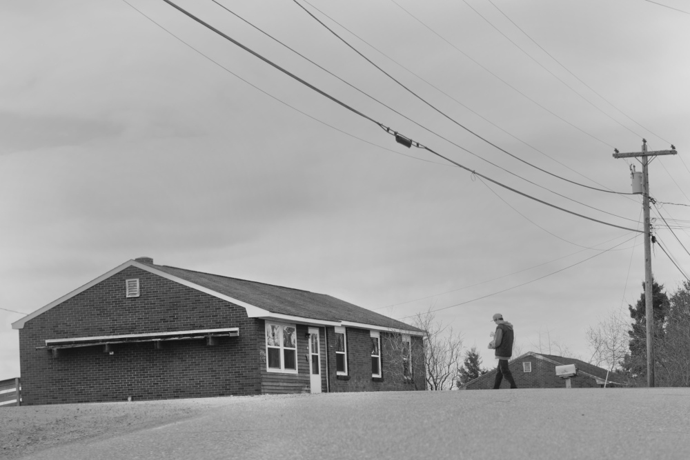 A man crosses Indian Road on the Passamaquoddy reservation at Pleasant Point this spring. In the 1960s, relations between law enforcement and the Indians living here had long been strained, both because of what sheriffs and state police would do and what they wouldn’t.