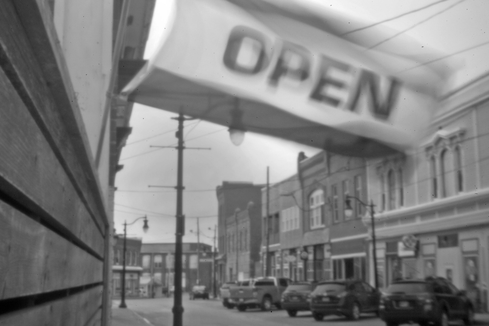 An “open” flag flies above a storefront in Eastport, not far from where the Passamaquoddy’s attorney Don Gellers had his office in the early 1960s, before his former legal intern, Tom Tureen, took over as the tribe’s representative in the Indian land claims lawsuit.