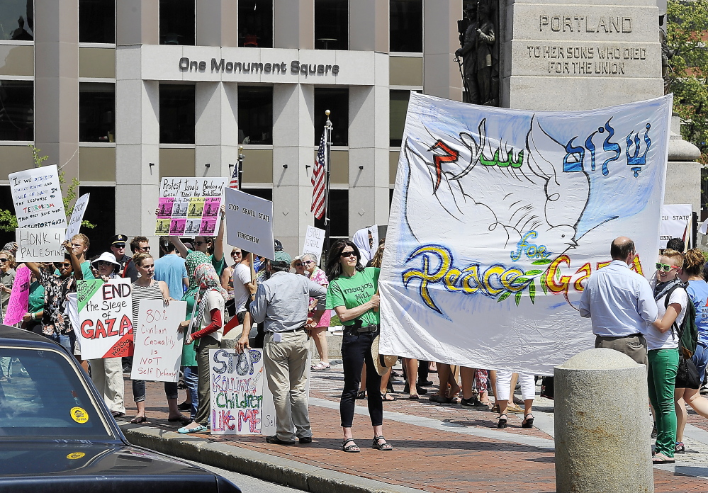 Pro-Palestinian protesters denounce Israel for the ongoing violence in Gaza during a rally in Portland’s Monument Square on Friday. The protest, the third in Portland in three weeks, took place as Secretary of State John Kerry pushed for a cease-fire agreement.
PORTLAND, ME - JULY 24: Pro-Palestinian protesters condemn Israel in a protest in Monument Square. (Photo by Gordon Chibroski/Staff Photographer)