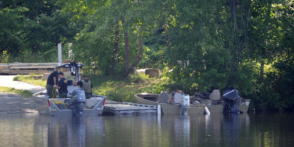 Search boats dock on the banks of the Kennebec River at the Madison boat launch on Friday. Authorities recovered the body of Jordan Cummings at 8:55 a.m.