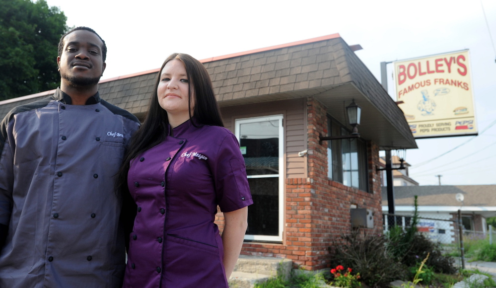 Bruce Hunter and Meagan McAvoy Hunter, stand outside Bolley’s Famous Franks and Gourmet Burgers on College Avenue in Waterville on Friday.