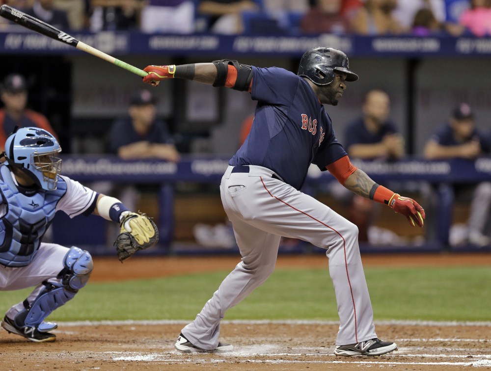 Red Sox designated hitter David Ortiz hits an RBI single off Rays starting pitcher David Price in the sixth inning Friday in St. Petersburg, Fla. Rays catcher Jose Molina, left, looks on. Dustin Pedroia scored on the hit.