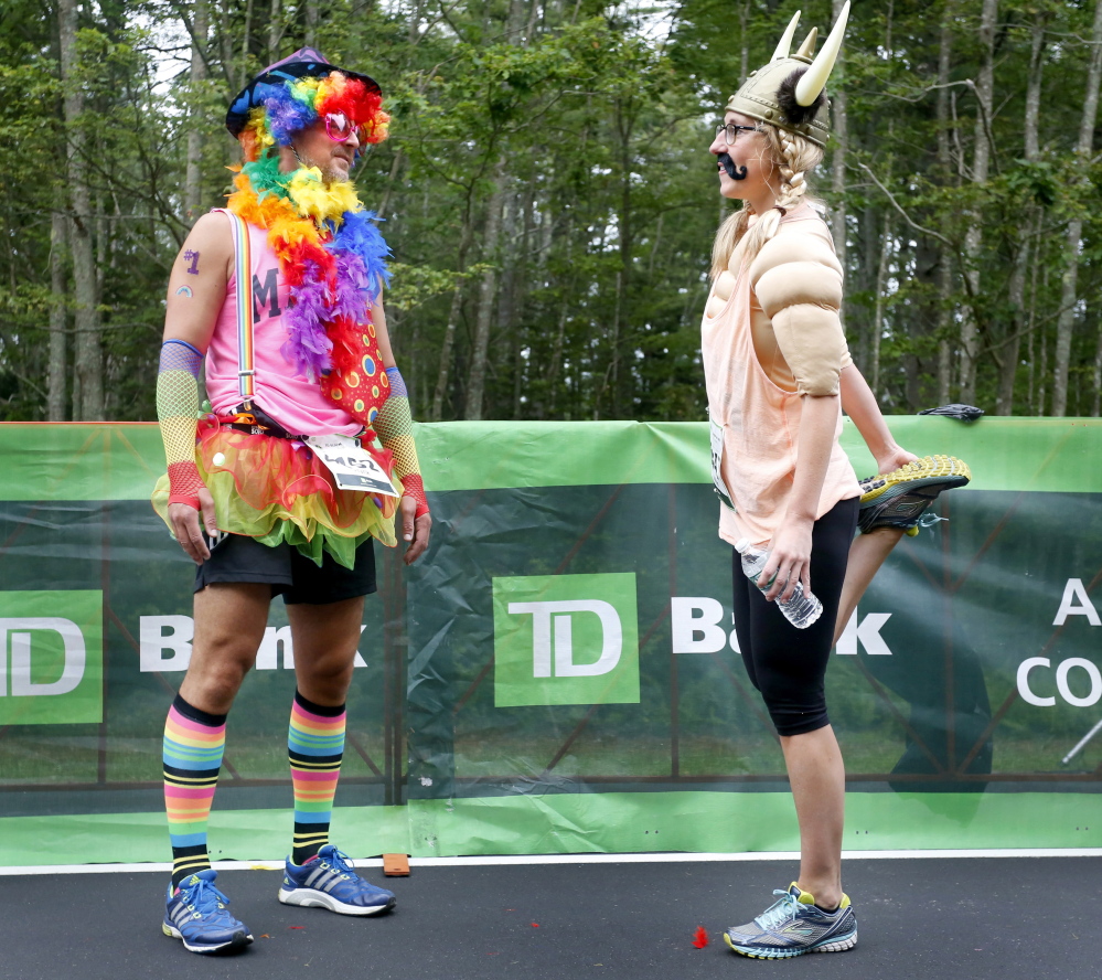 Jennifer Rice and Frank Femin of Portland stretch before the start of the TD Beach to Beacon 10K in Cape Elizabeth on Saturday.
