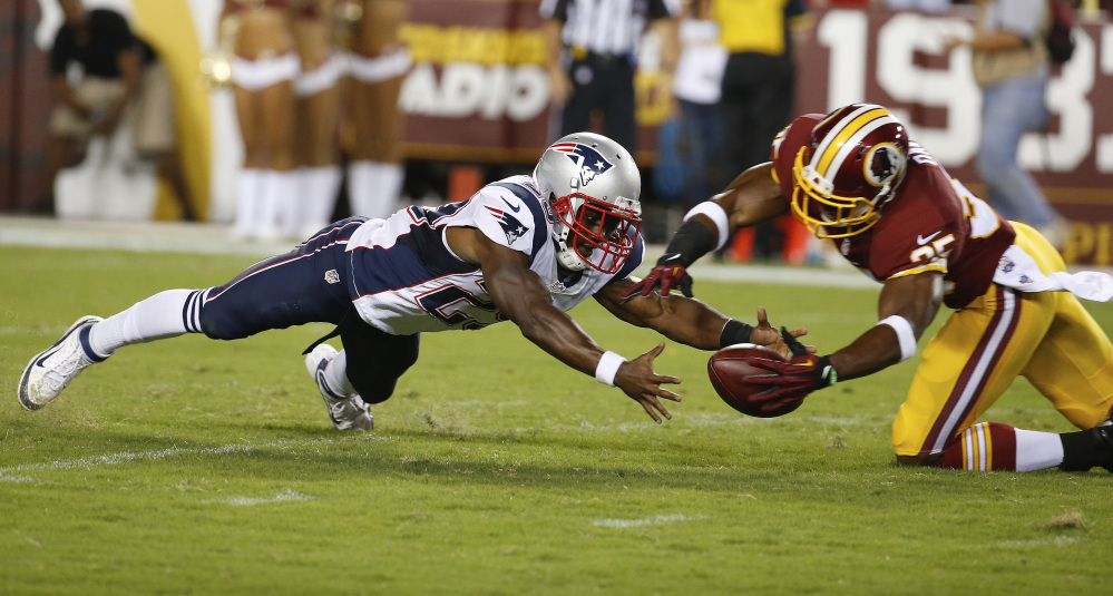 New England Patriots running back Roy Finch and Washington defensive back Akeem Davis chase a loose ball in the second half of their preseason game in Landover, Md., on Thursday.