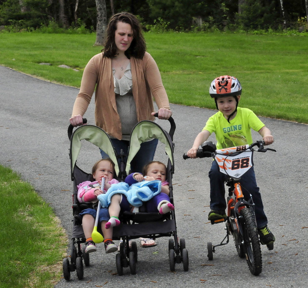 Emily Walker with her children two weeks after twin 2-year-old daughters, Maddilyn, left, and Brooklyn were hurt in what police charged was a beating administered by David Devine, Walker’s boyfriend. Brother Wyatt, 4, tags along.
