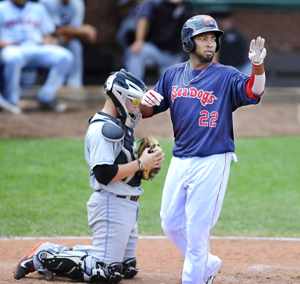 Portland’s Keury De La Cruz gives the sign while crossing the plate after hitting a home run. Press Herald File Photo/Gordon Chibroski